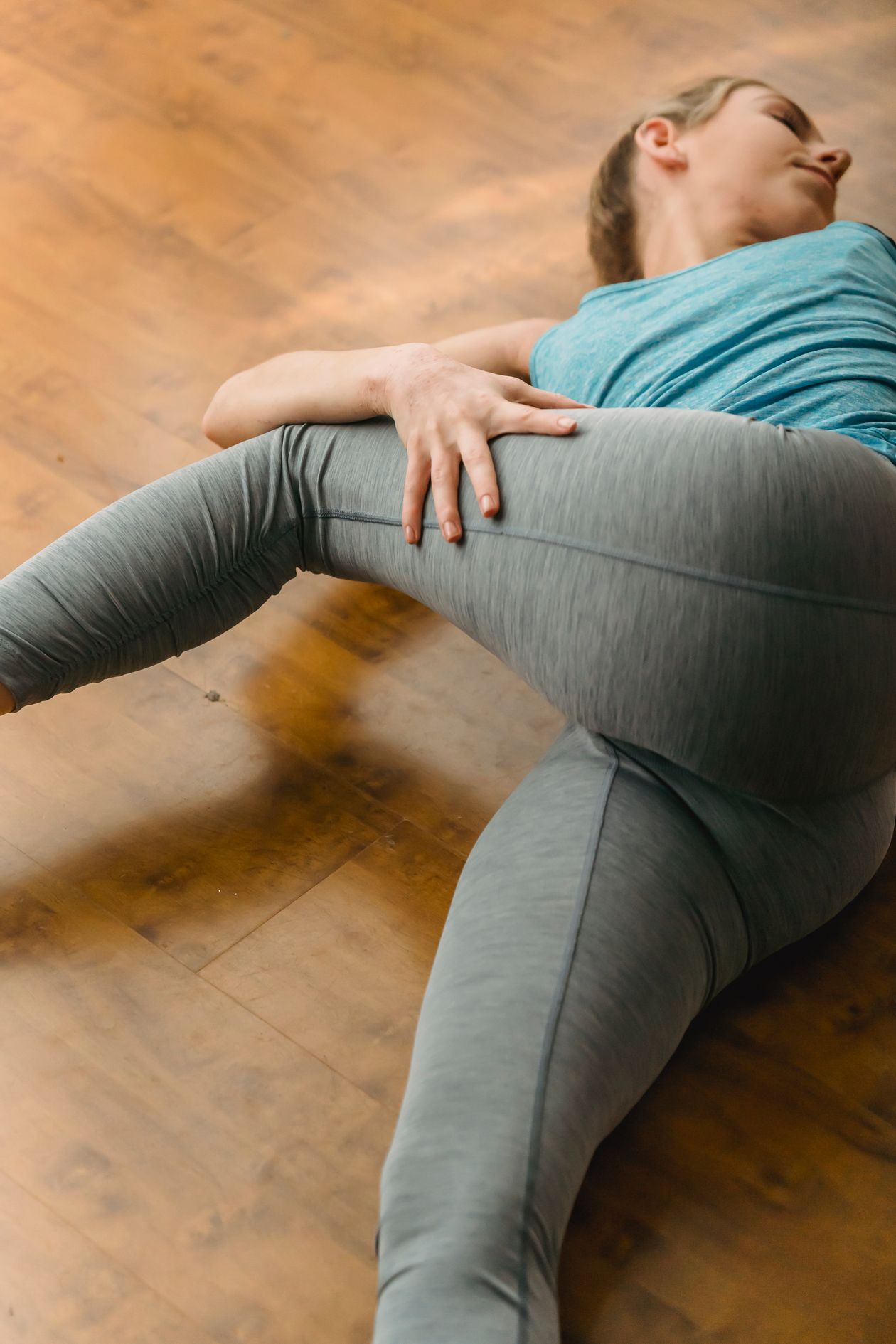 woman doing a hip mobility stretch on the floor for flexibility after 40