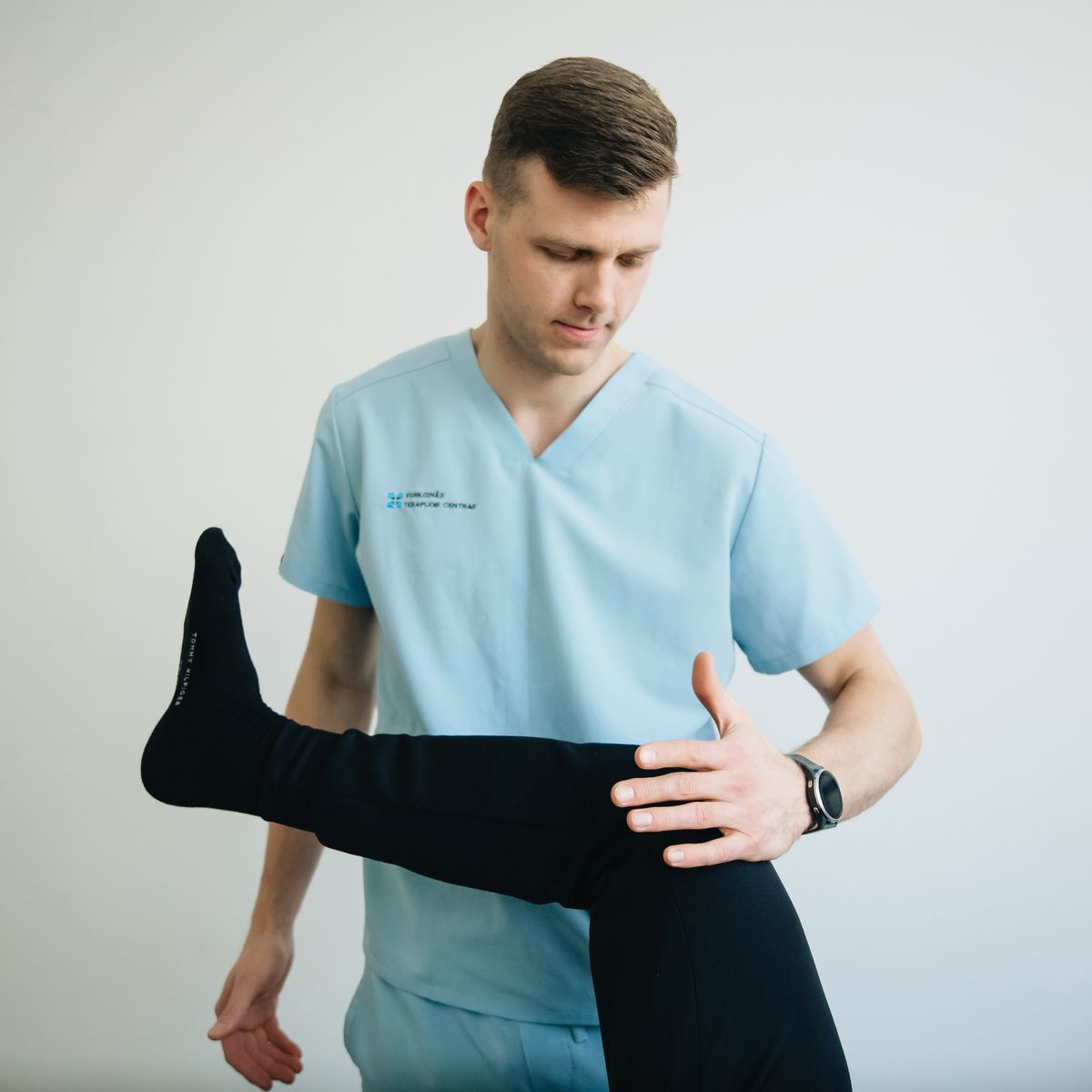physiotherapist treating patient with knee pain