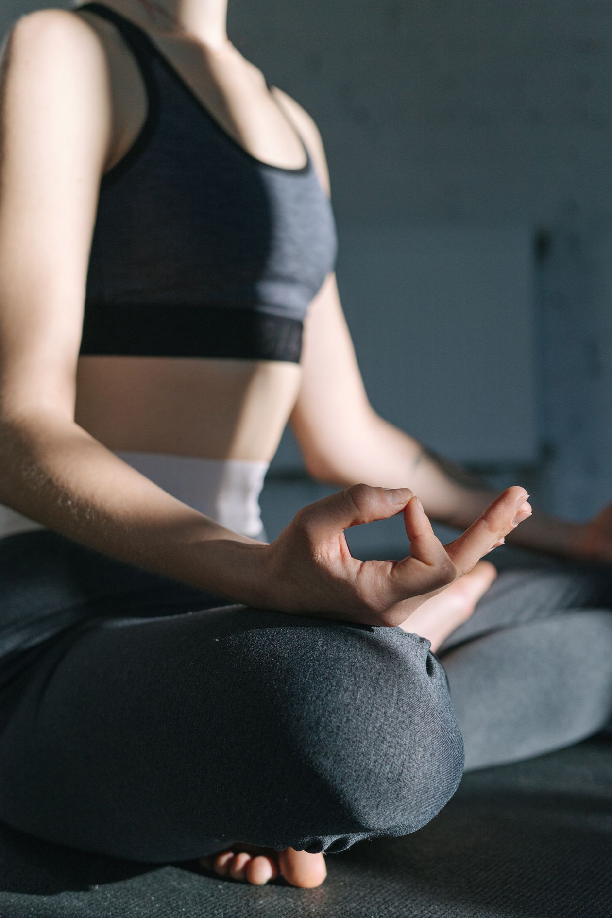 woman practicing yoga and meditation indoors for mindfulness and joint pain stress management