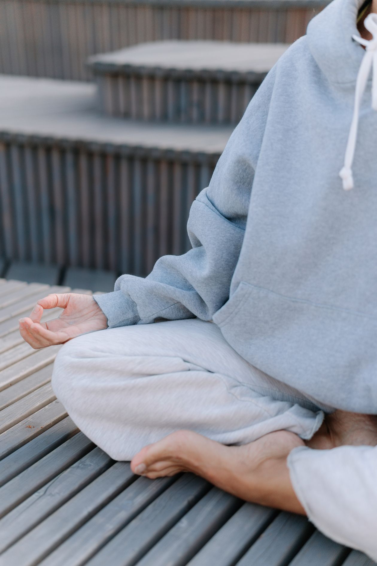 person meditating outdoors in comfortable clothing for stress reduction and pain management