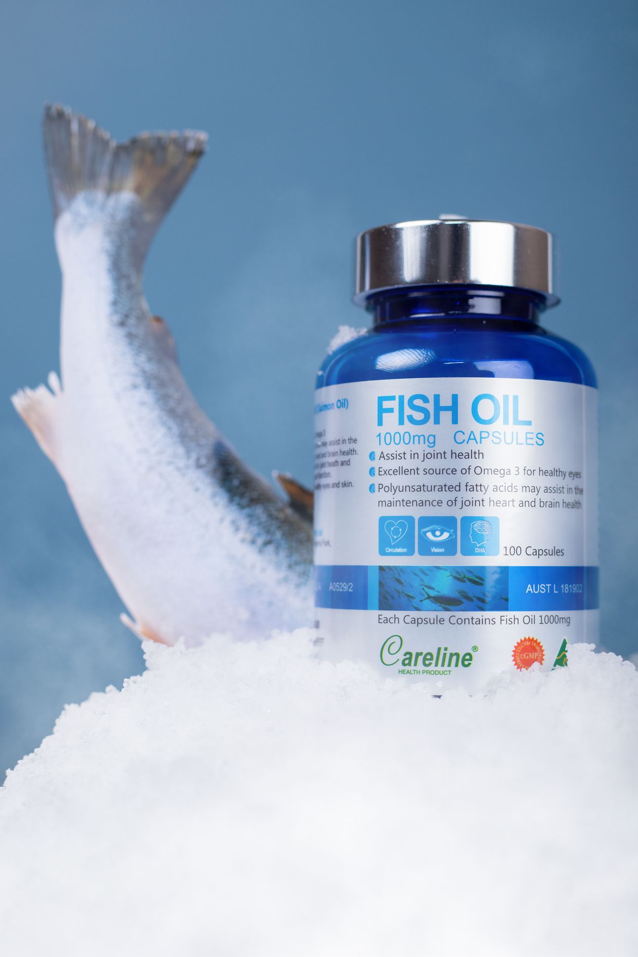 fish oil capsules displayed with fresh salmon on ice showing natural sources of omega-3 for joint health