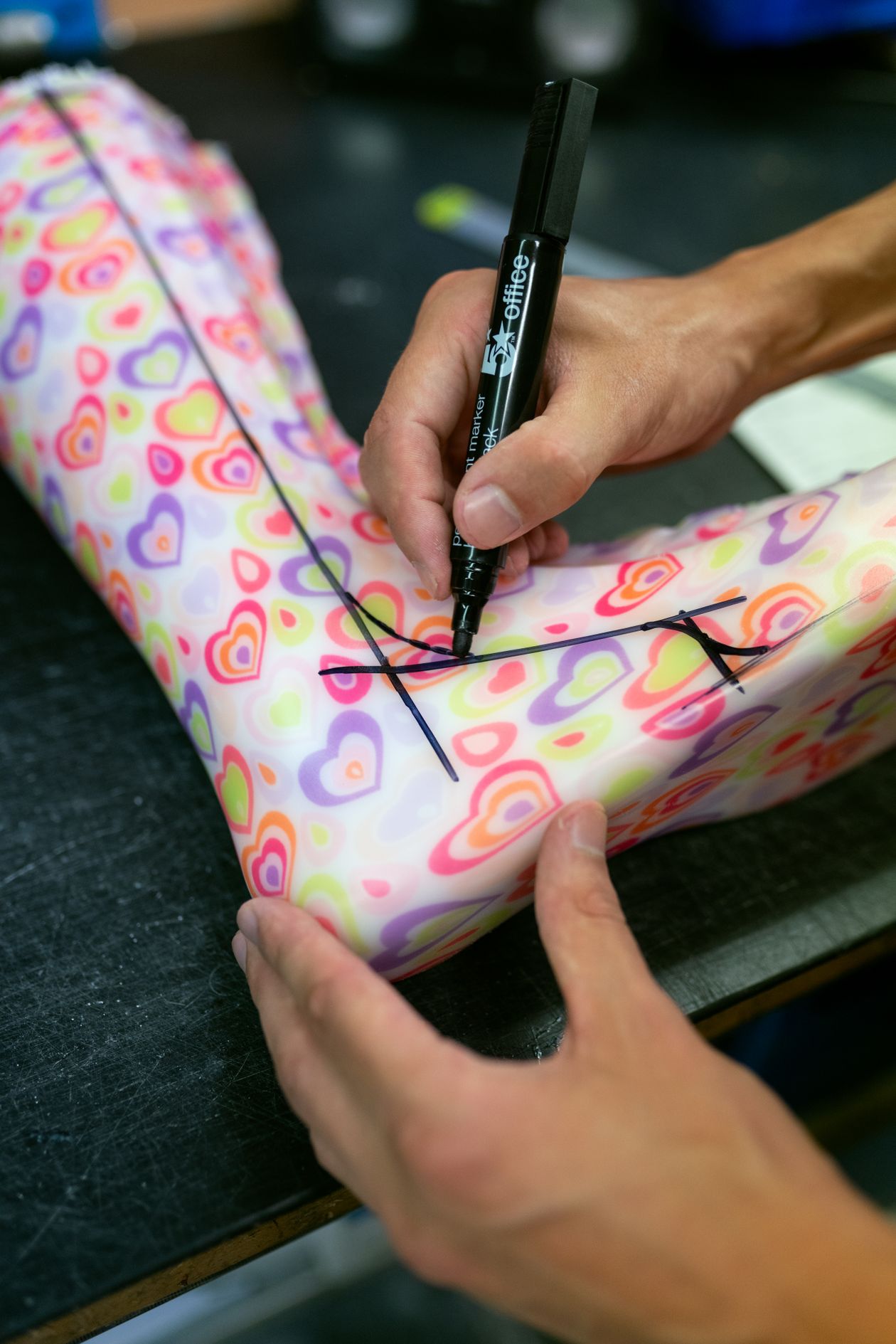 orthotics technician working on custom brace design using specialized equipment