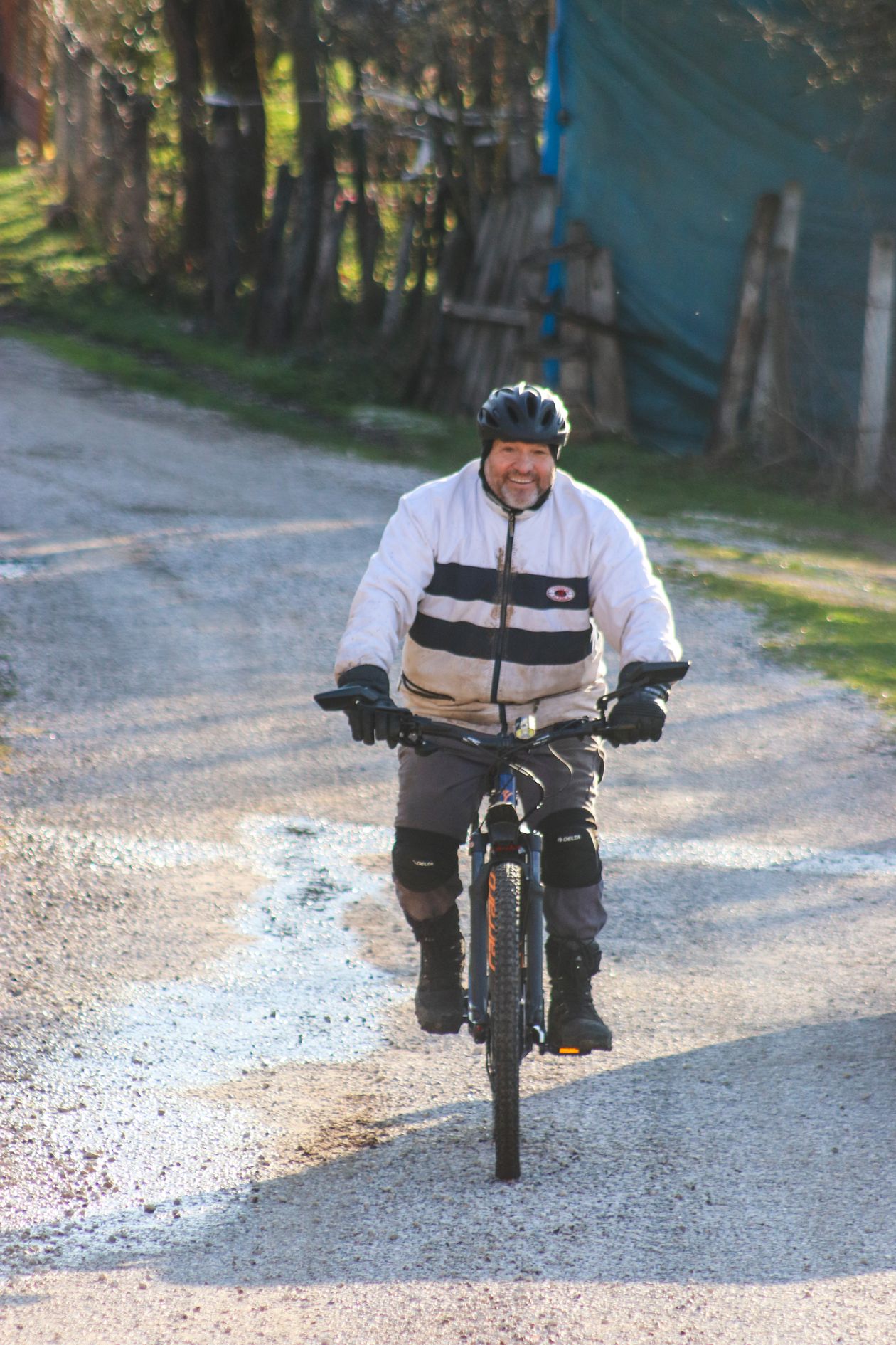 senior man cycling on a rural road showing outdoor cycling for active aging and joint health