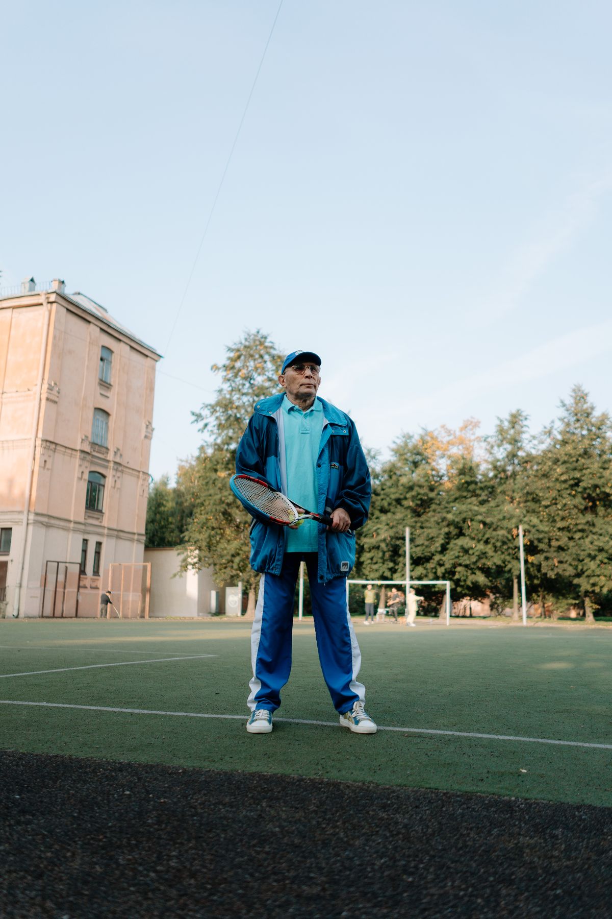 elderly man playing tennis outdoors active aging and independence