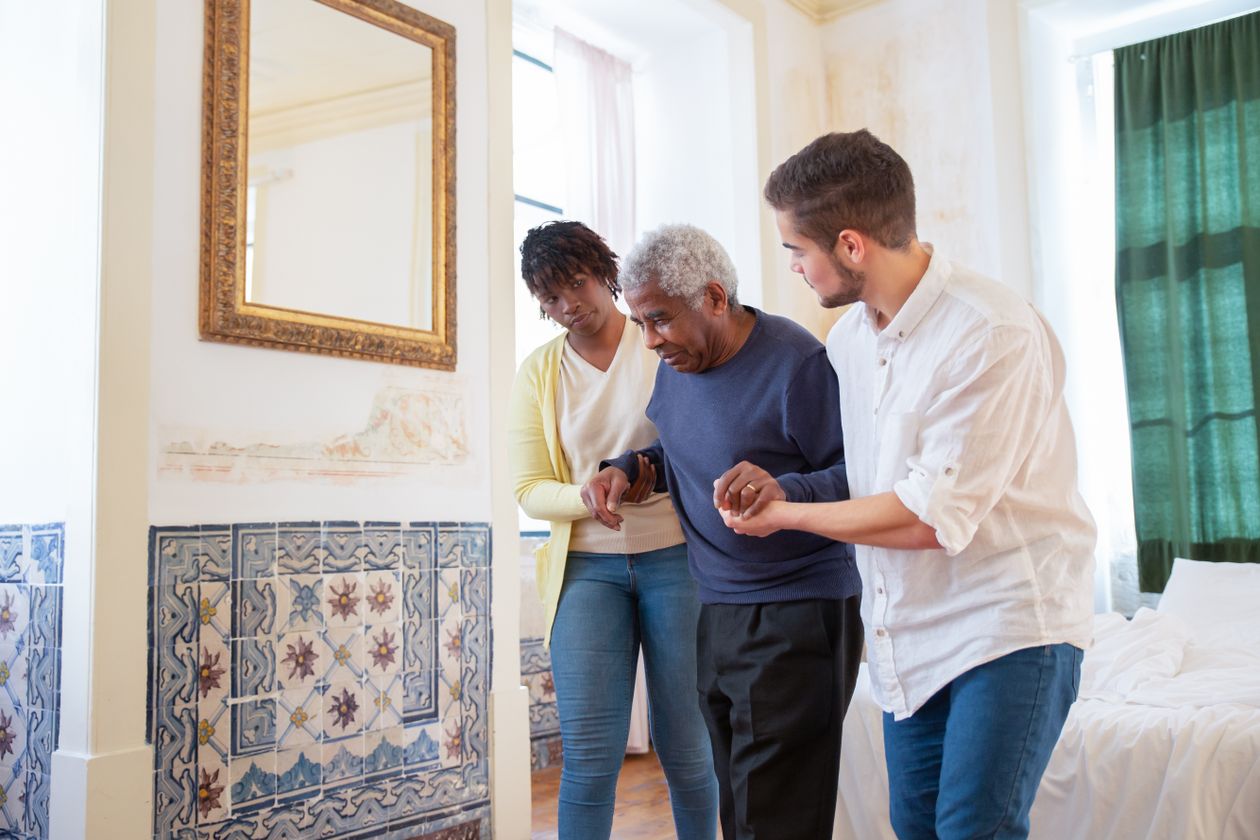 senior receiving walking assistance at home showing mobility support and fall prevention strategies for older adults