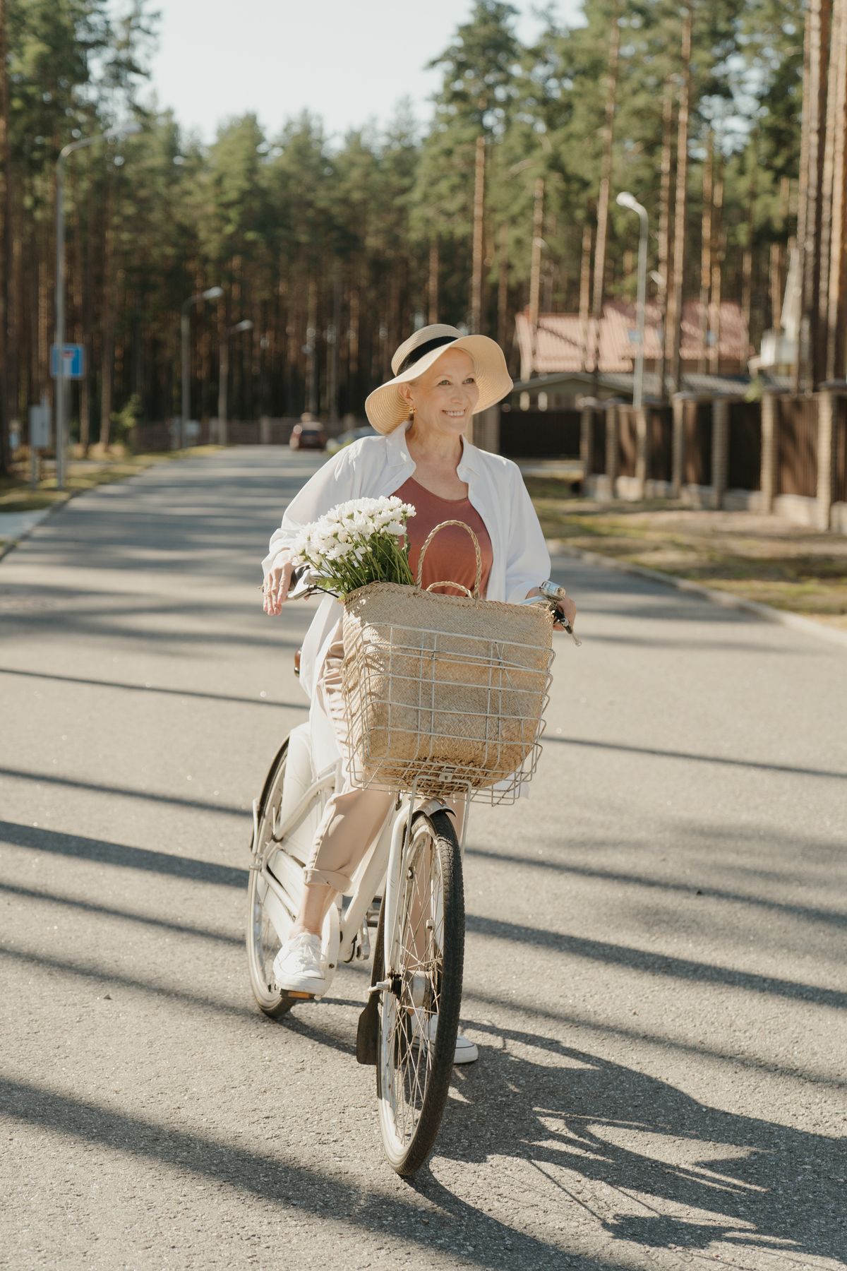 elderly woman riding bicycle outdoors active lifestyle after 40