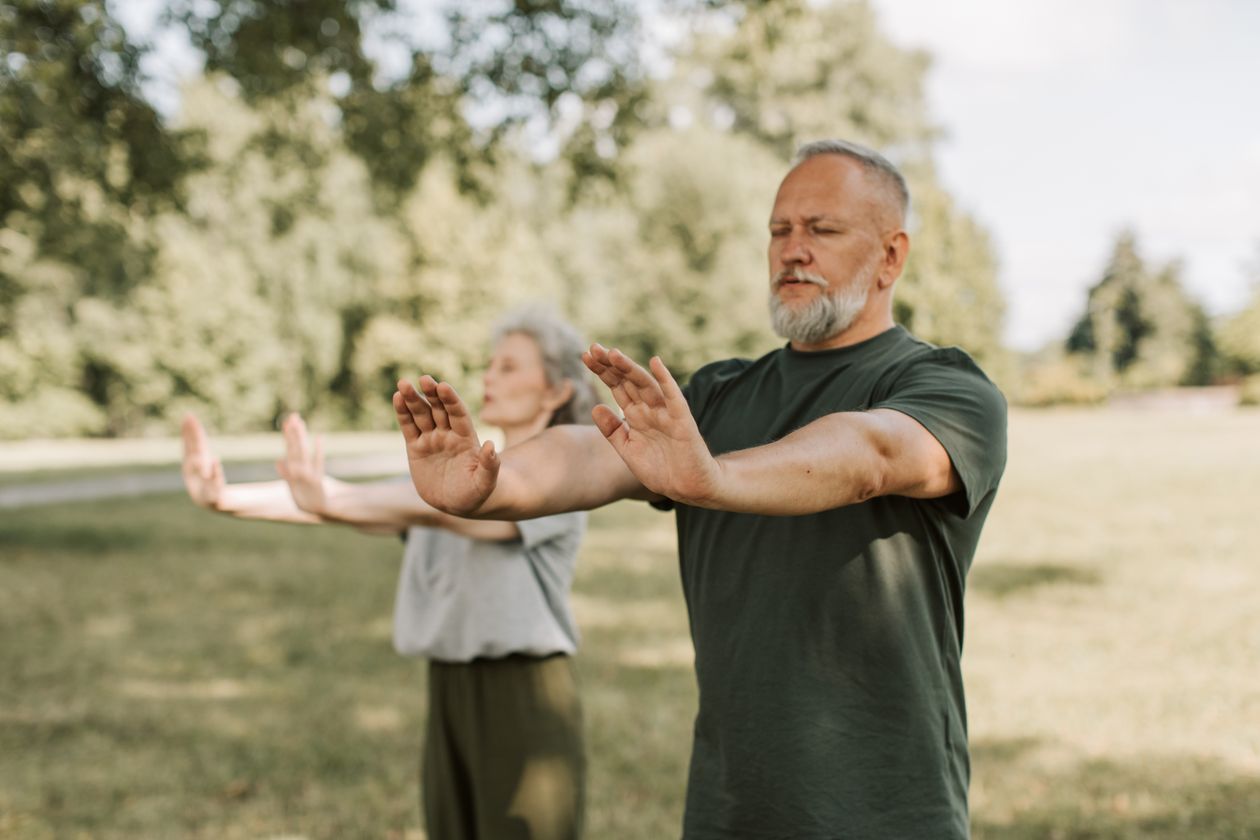 elderly couple engaged in outdoor tai chi promoting wellness balance and active aging through mindful movement