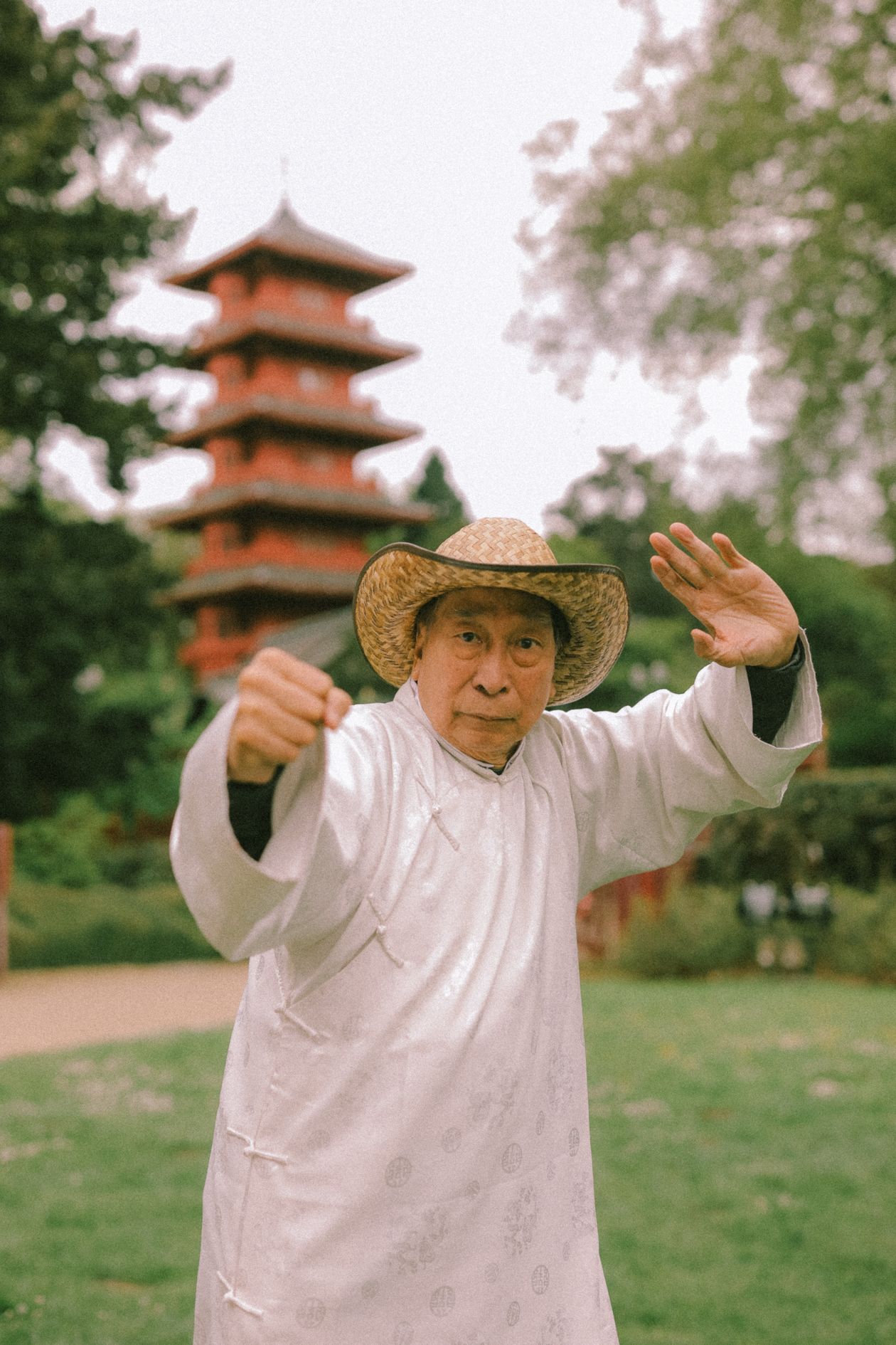 senior man in traditional attire practicing tai chi in a serene garden setting showing tai chi for joint health after 40