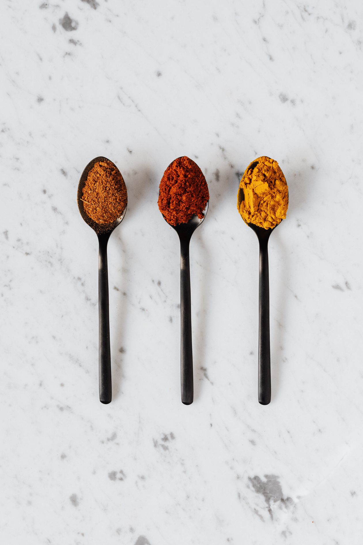 turmeric powder and spices arranged on marble surface for natural joint pain relief