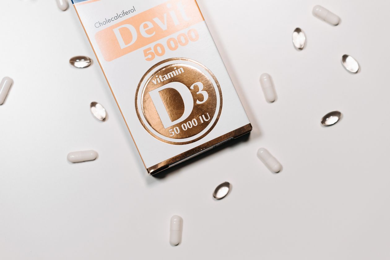 vitamin D3 supplement box and capsules on light background showing D3 supplementation