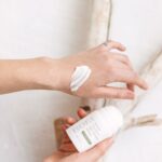 person applying topical joint cream to hands showing how topical pain relief works for arthritis and joint stiffness in adults over 40