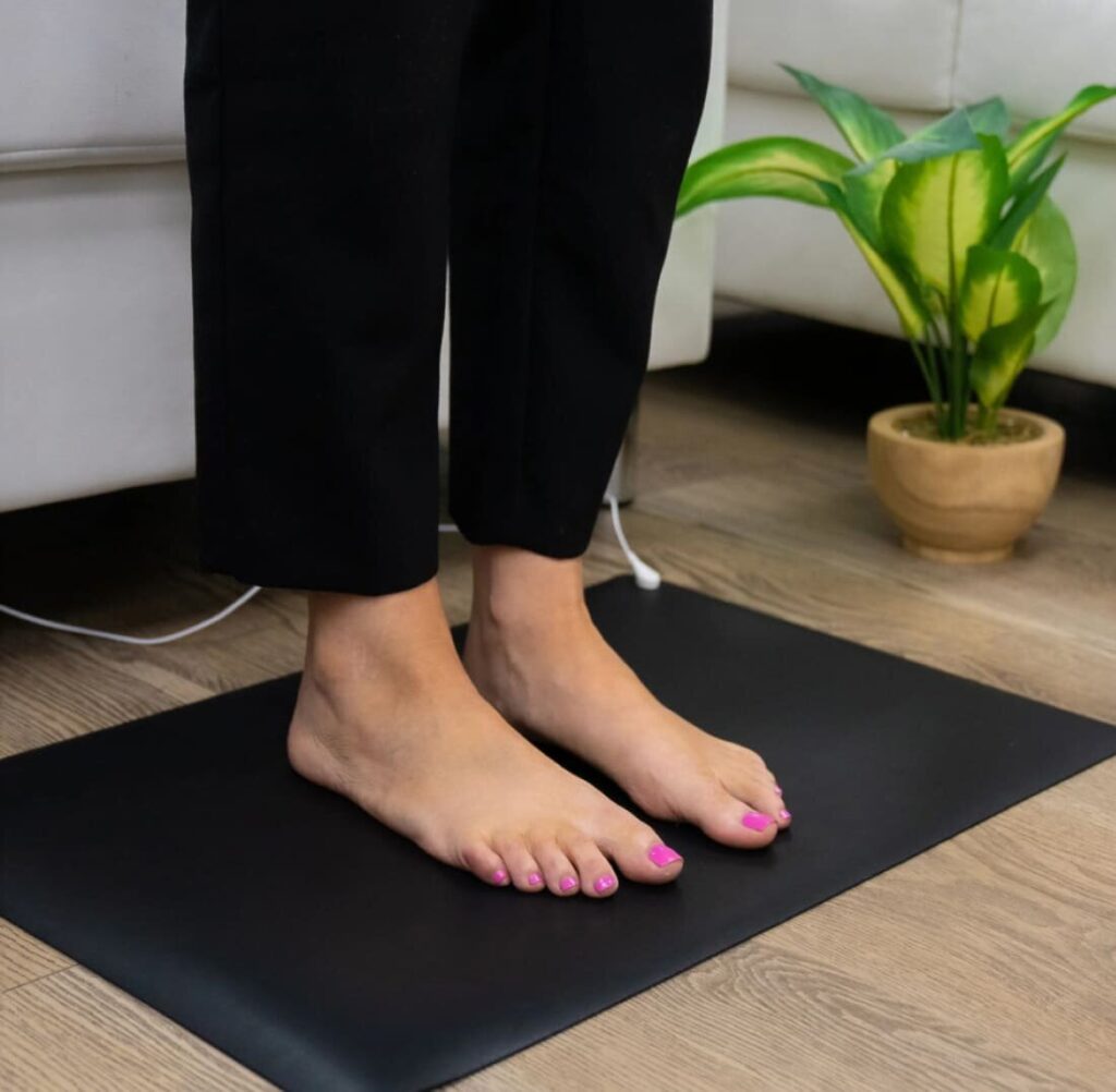 Bareflowmat grounding mat in use with bare feet showing direct skin contact for earthing therapy at home