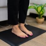 Bareflowmat grounding mat in use with bare feet showing direct skin contact for earthing therapy at home