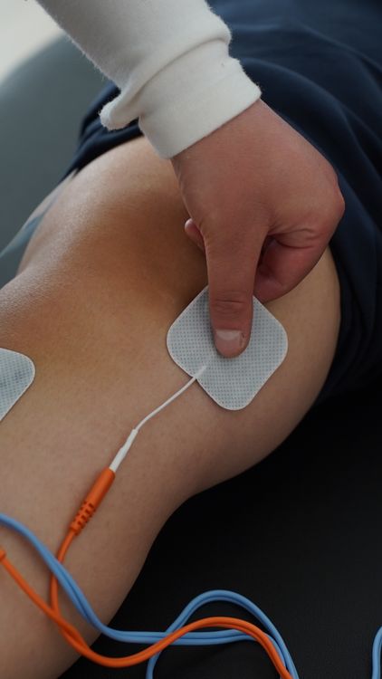 Therapeutic electrostimulation device applied to knee joint for pain relief representing non-invasive treatment approaches for adults over 40