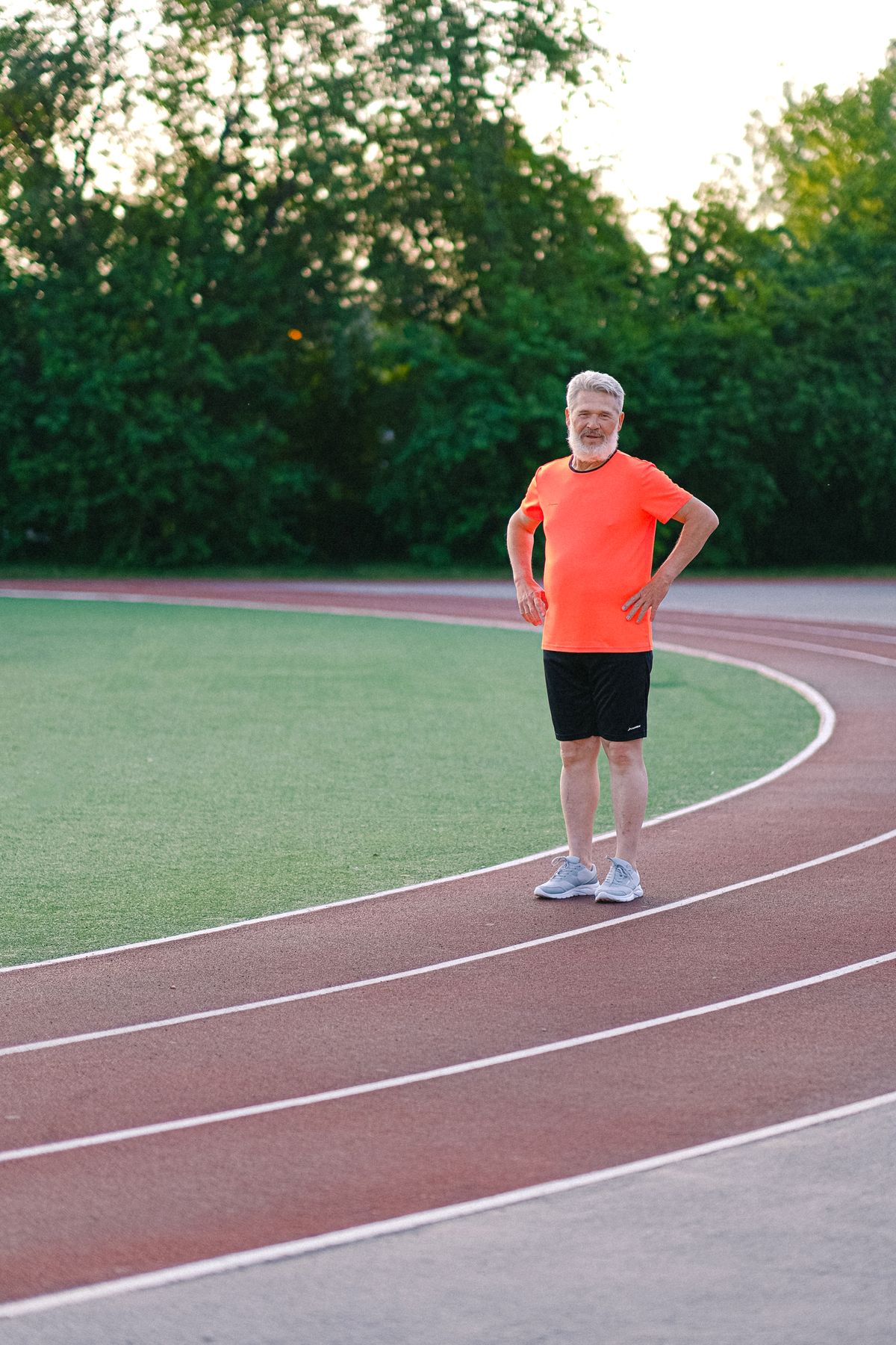 Adult over 40 doing aerobic exercise on a track, the training that lowers resting heart rate and raises HRV over months