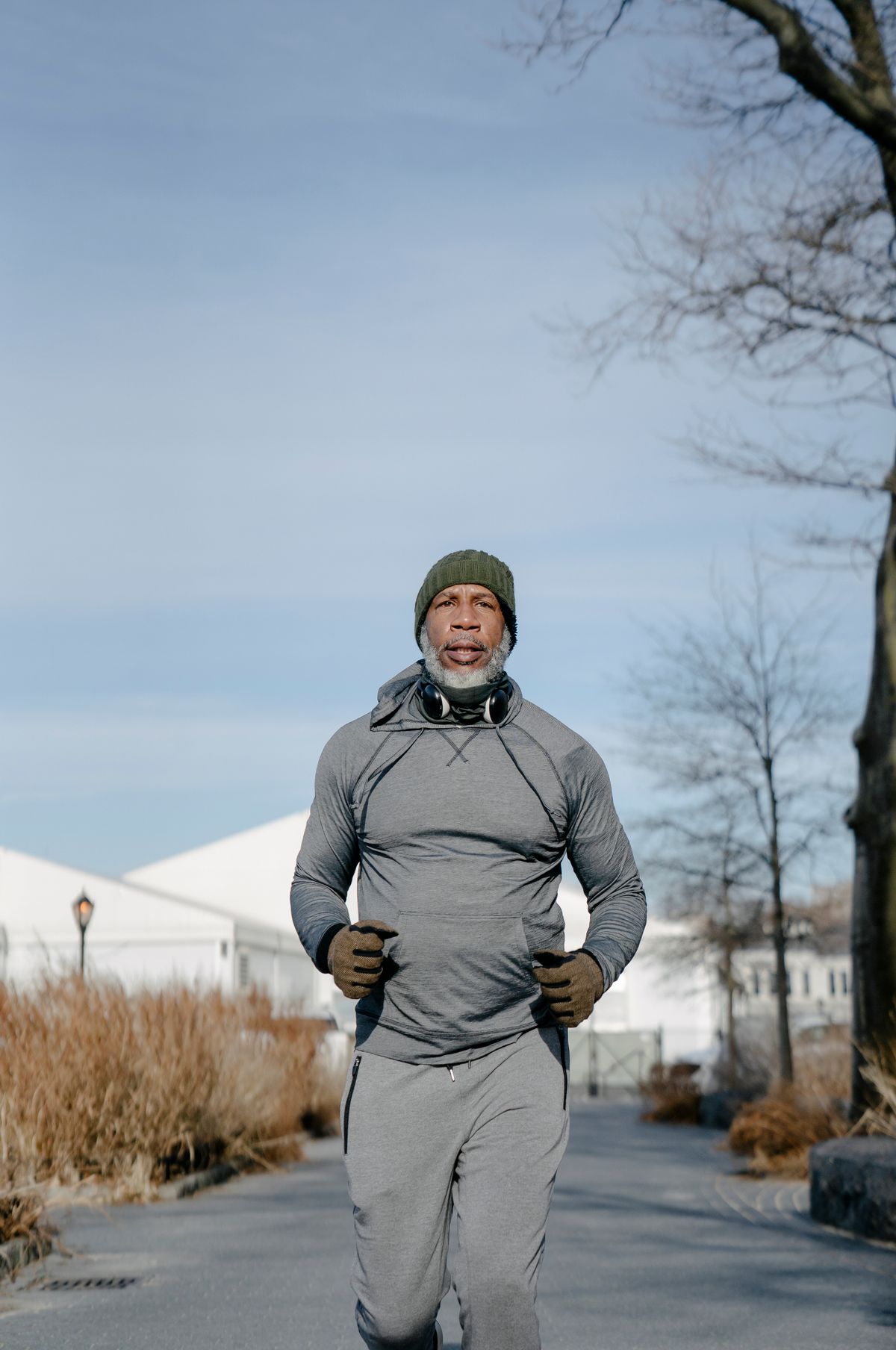 Active adult over 40 exercising outdoors, tracking training strain and recovery