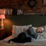Adult over 40 asleep while a screenless wearable tracks sleep stages and overnight HRV