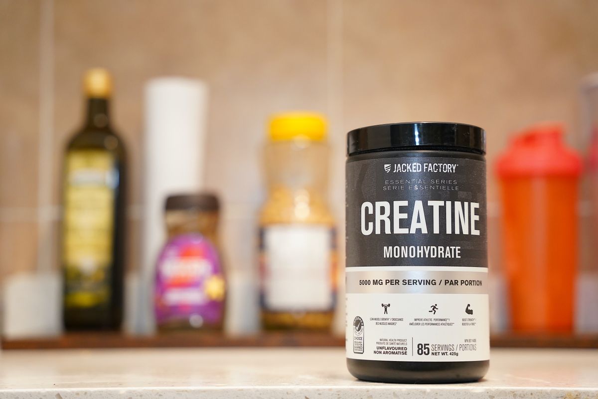 creatine monohydrate powder and a measuring scoop, a supplement commonly used for muscle and joint support after 40