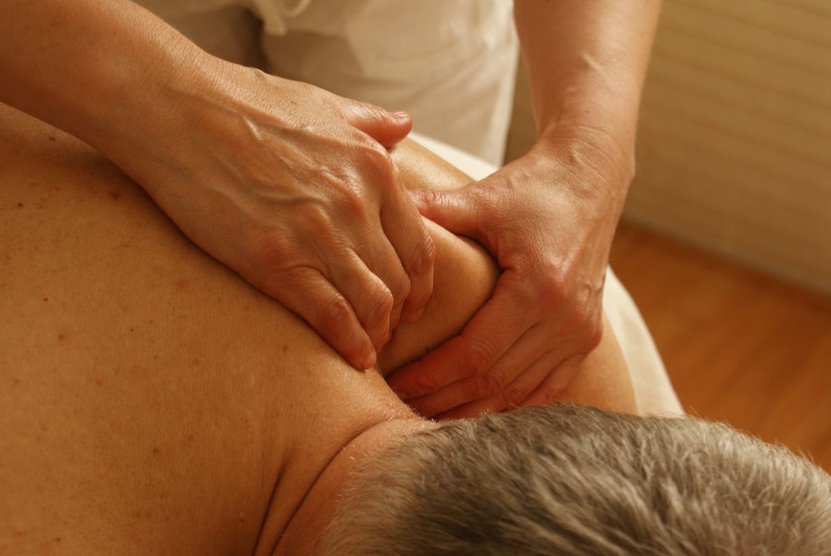close-up of a therapist working on a patient's shoulder to relieve frozen shoulder stiffness