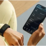 Hume Band 2.0 on the wrist next to the Hume Health app showing daily activity data