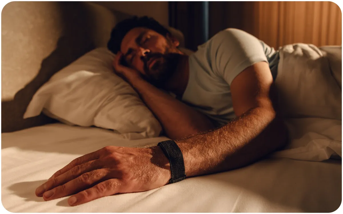 Man sleeping while wearing the Hume Band 2.0 for overnight tracking